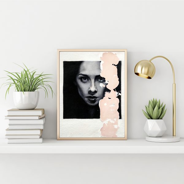 "Black and white serie 7" modern portrait with pink textured line with gold metal frame standing on the table with succulent plant, lamp and pile of books on empty white wall background.