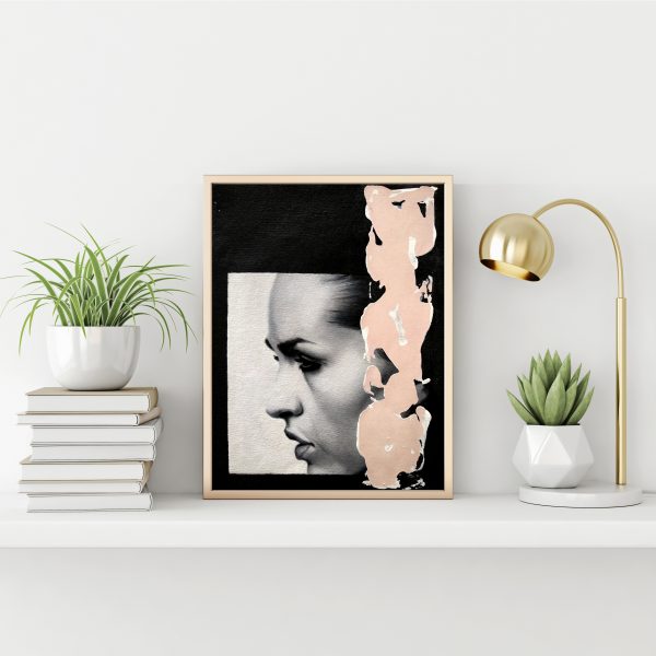 "Black and white serie 10" modern portrait with pink textured line with gold metal frame standing on the table with succulent plant, lamp and pile of books on empty white wall background.