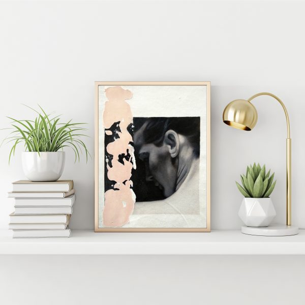 "Black and white serie 3" modern portrait with pink textured line with gold metal frame standing on the table with succulent plant, lamp and pile of books on empty white wall background.