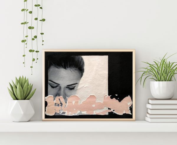 "Black and white serie 9" modern portrait with pink textured line with gold metal frame standing on the table with plants in pots and pile of books on empty white wall background